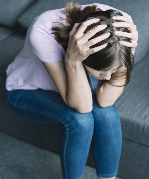 young-woman-suffering-from-headache-sitting-sofa young-woman-suffering-from-headache-sitting-sofa