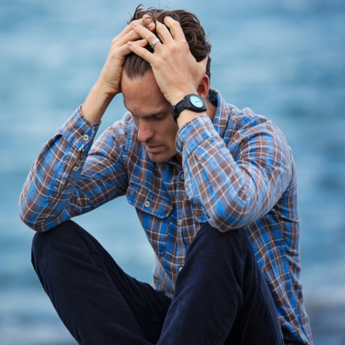 A man holding his head in distress A-man-holding-his-head-in-distress